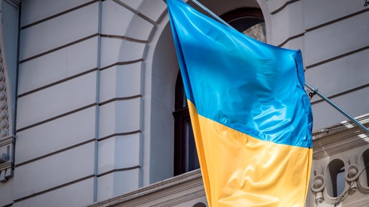 Ukraine flag hanging outside a building