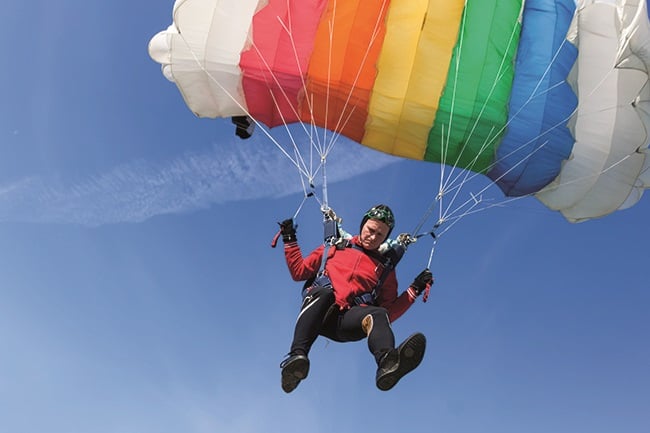 Man flying with parachute