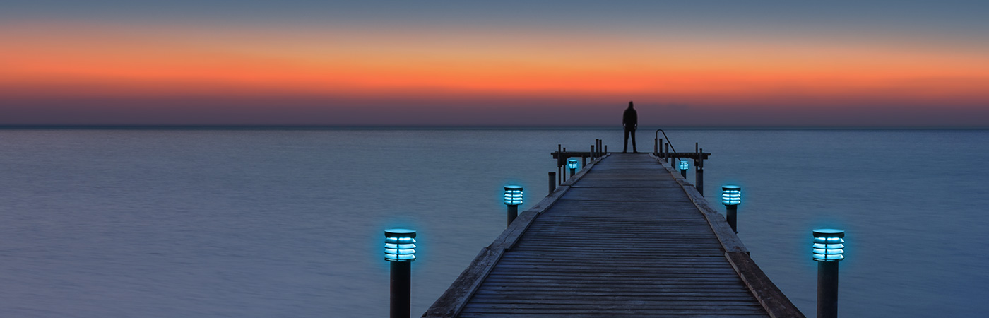 Man standing at end of a jetty